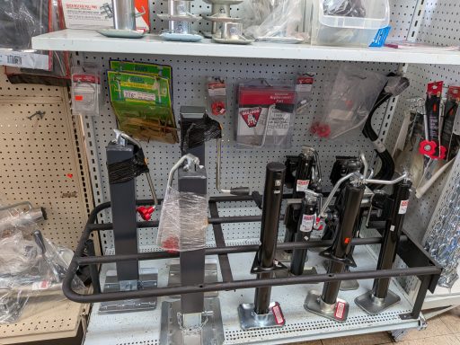 Display of various hardware tools and accessories on a retail shelf.